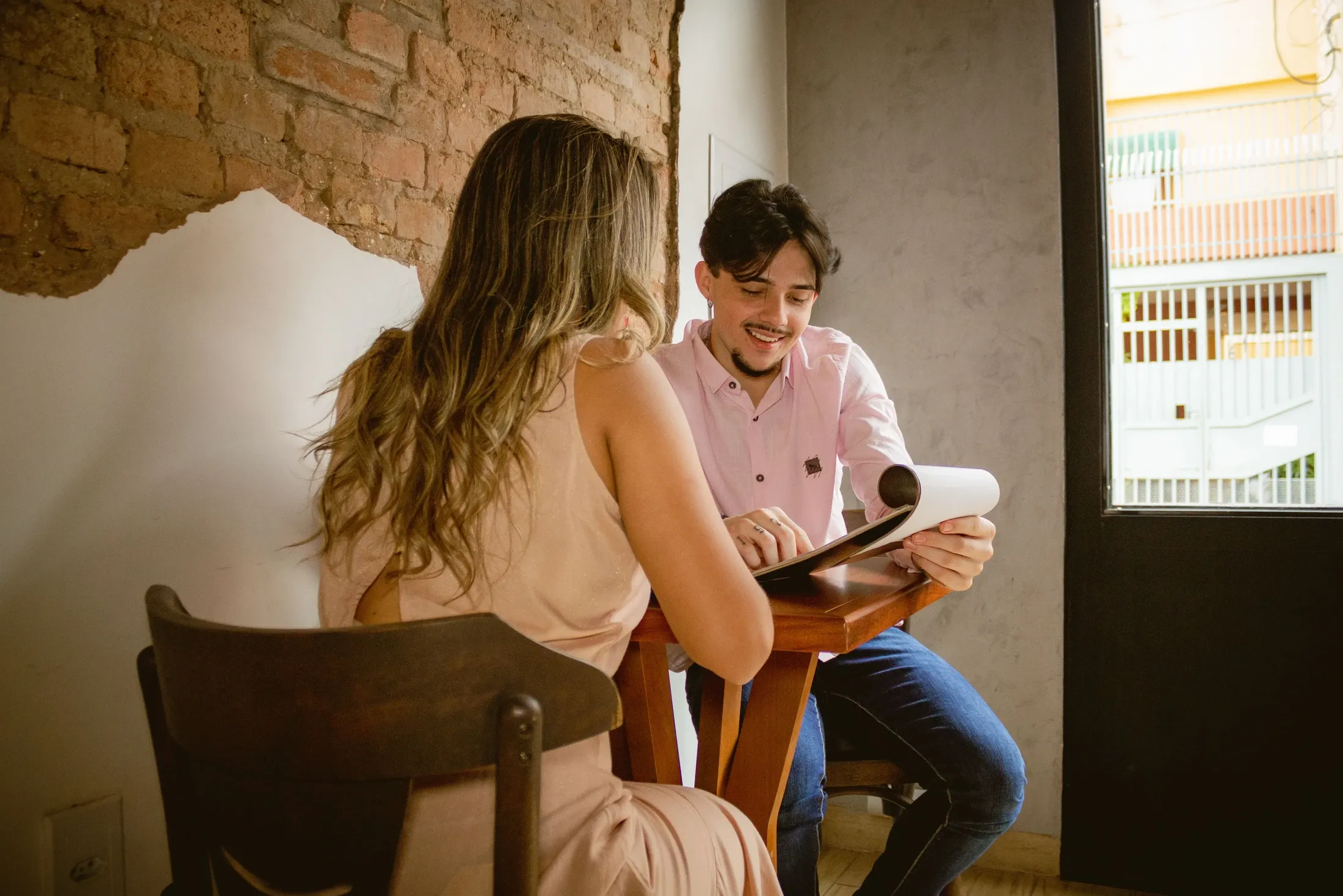 Dos personas revisando documentos durante una conversación de trabajo